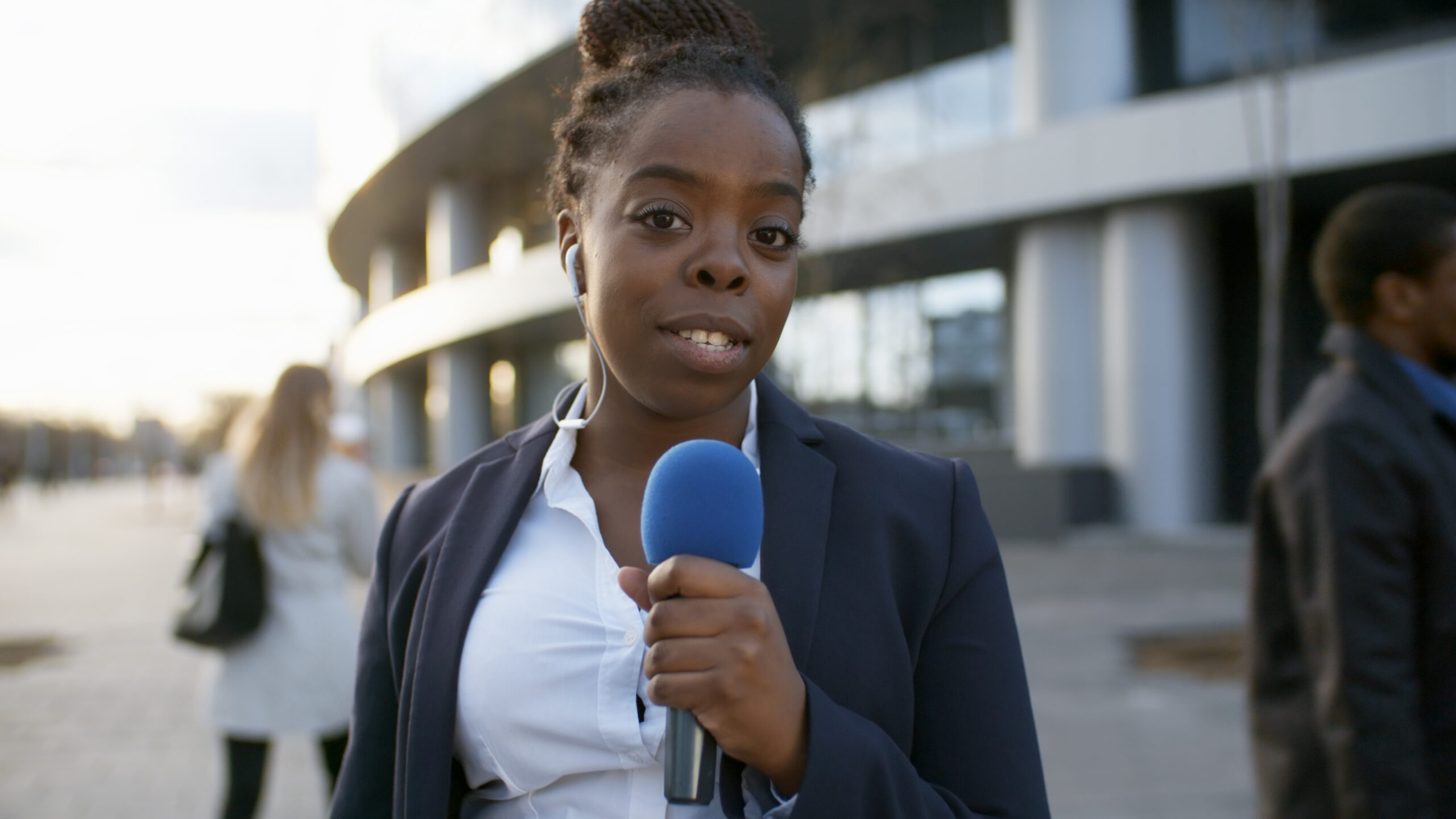 Reporter working at an active scene
