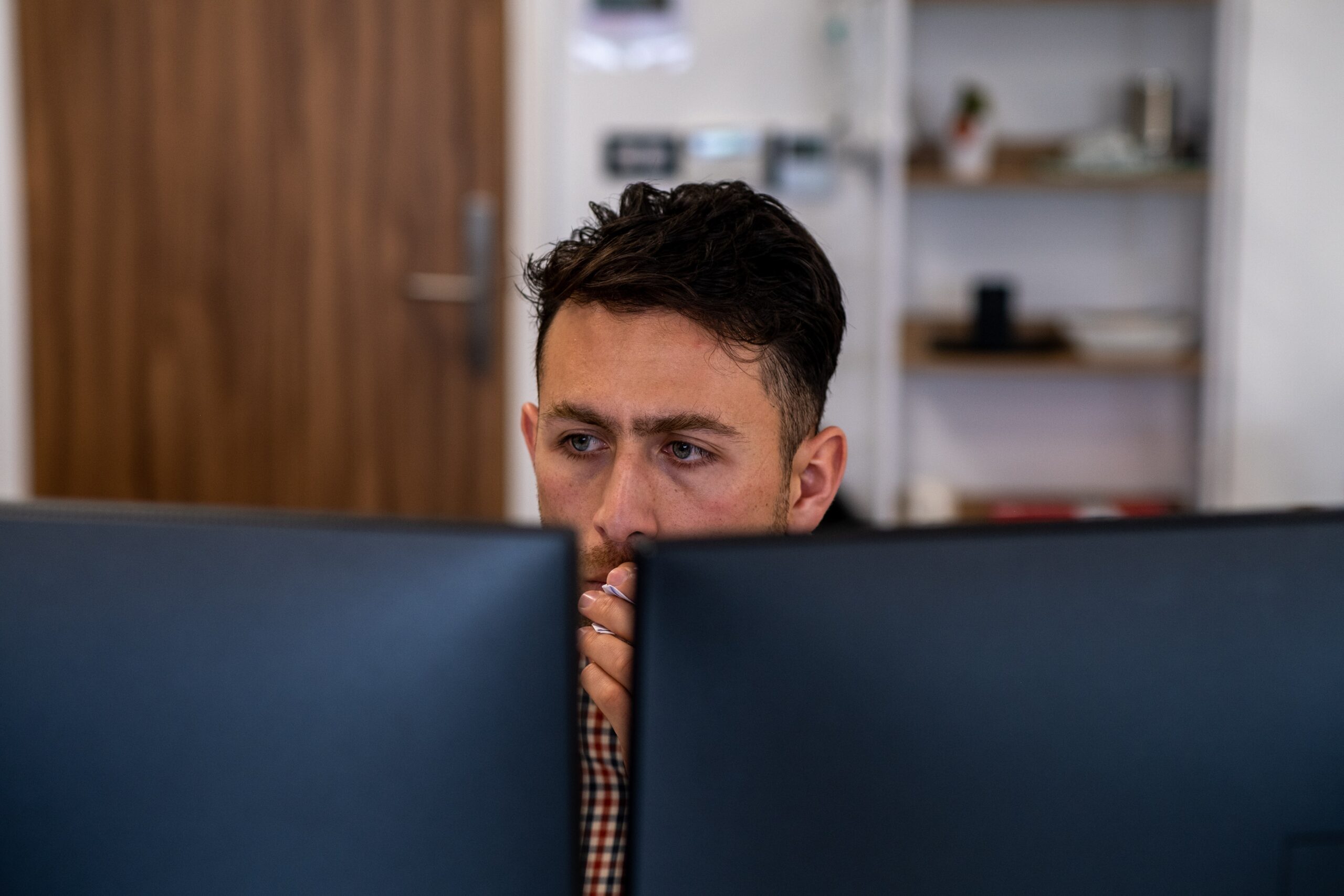 News Director working on a computer.
